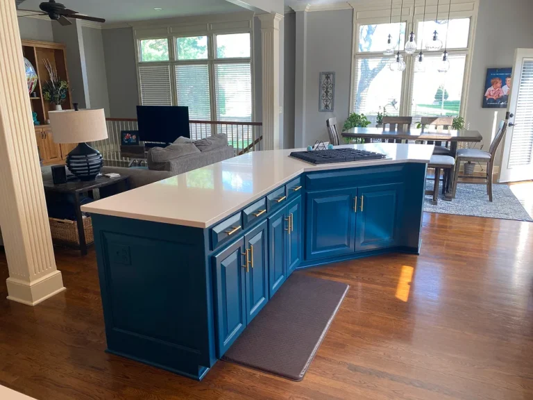 Blue kitchen island with white countertop and gold handles by Stag Homes Design-Build in Kansas City