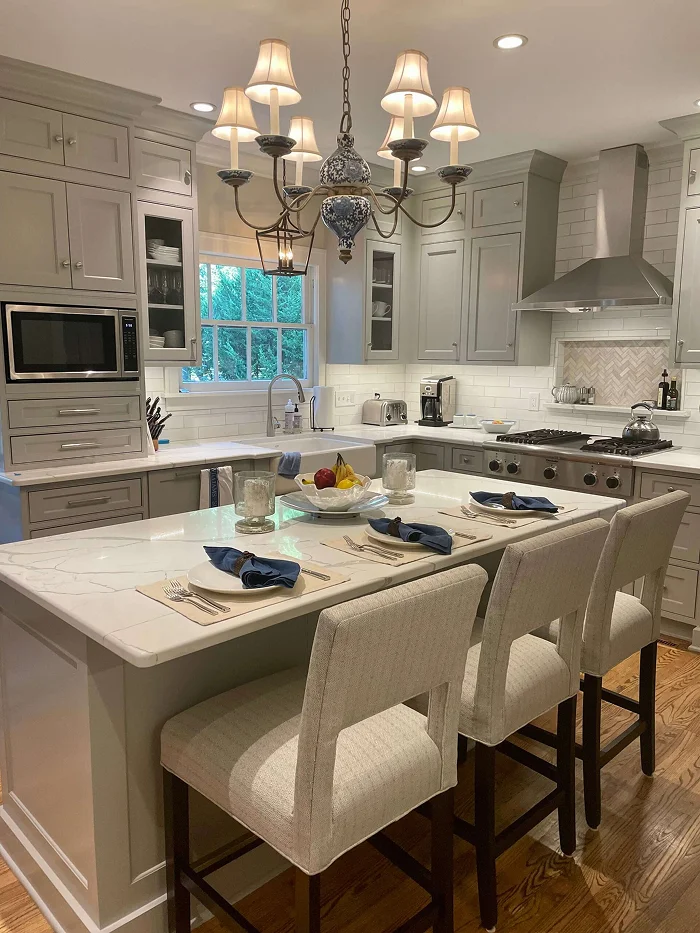 Elegant kitchen island with marble countertops and pendant lighting by Stag Homes Design-Build in Kansas City